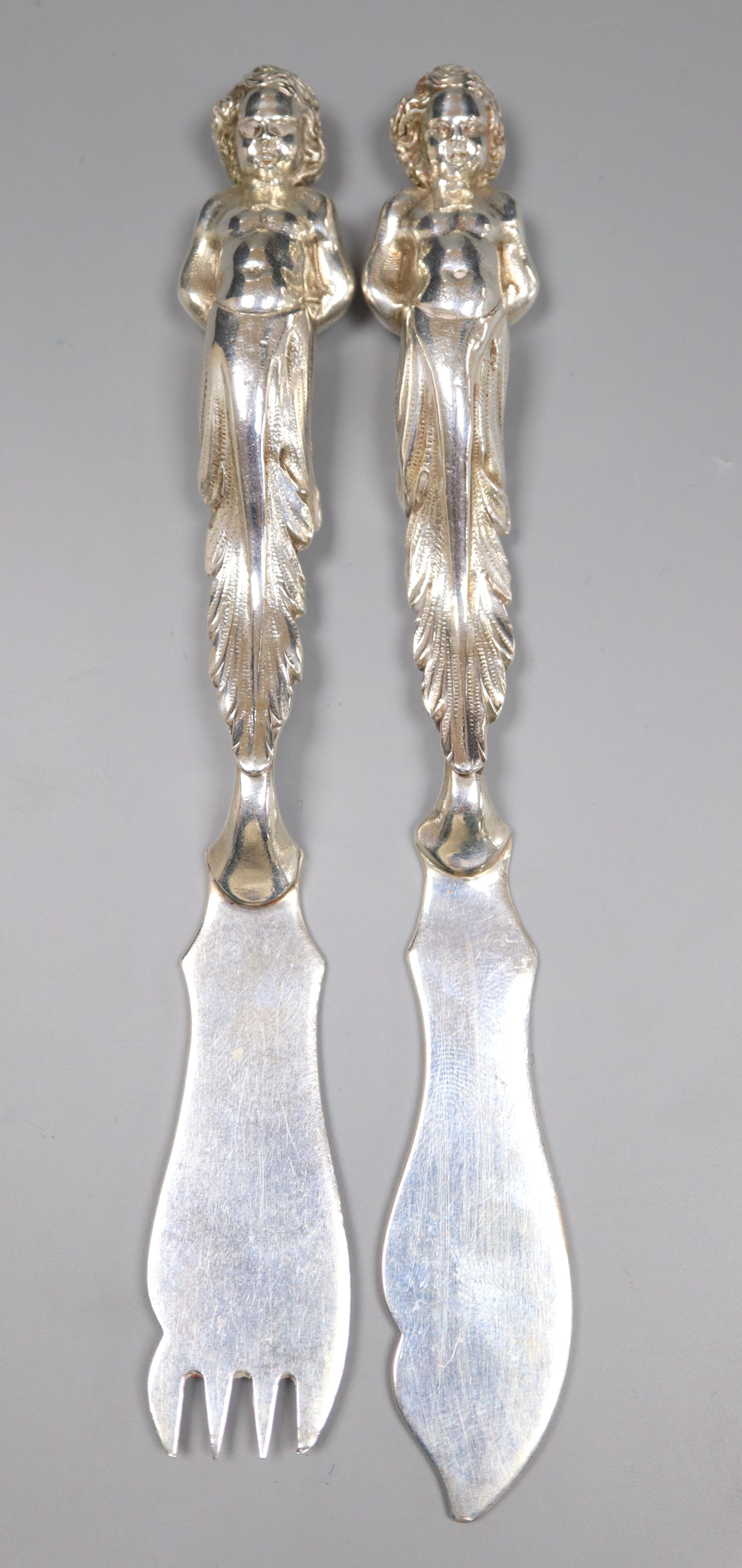 A pair of late Victorian silver fish eaters with figural handles by Goldsmiths & Silversmiths Co Ltd, London, 1898,